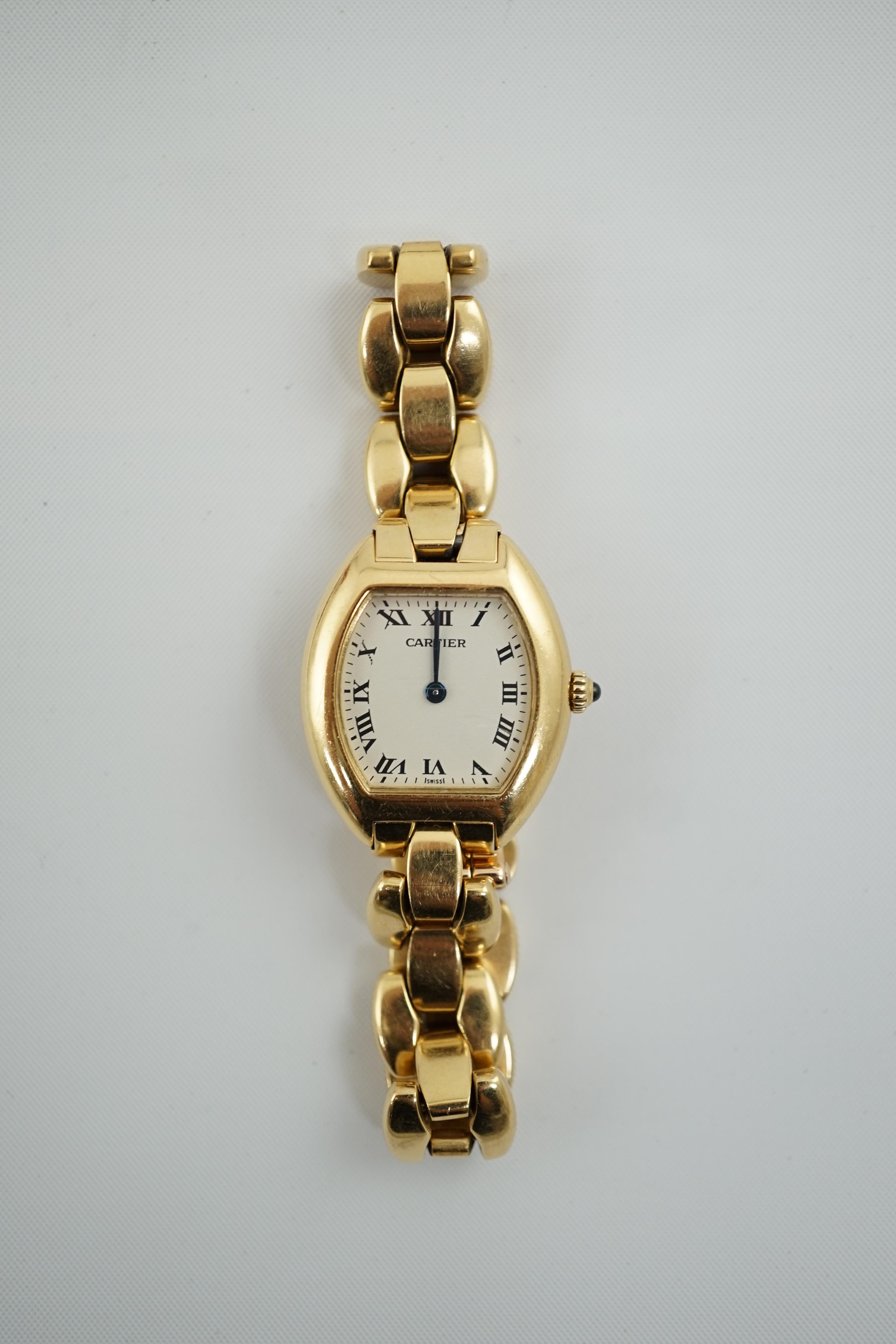 A lady's late 1990's? 18k gold Cartier quartz wrist watch, on an 18 k gold Cartier bracelet